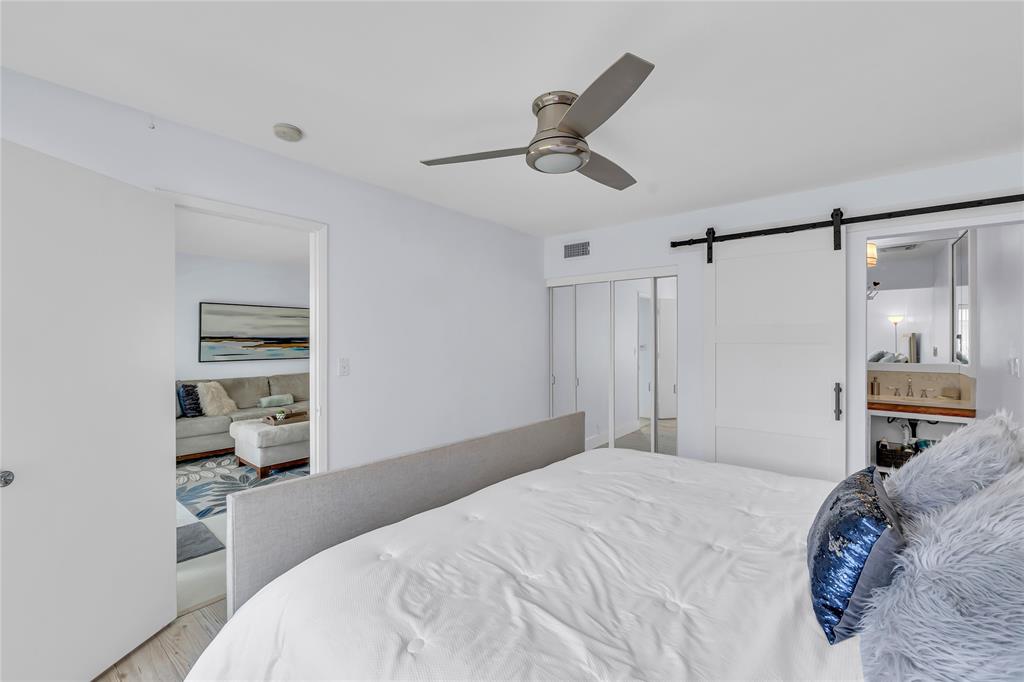 1198 Hillsboro Mile, Unit 212 Hillsboro Beach, FL 33062 - Photo 21 of 64 a bedroom with a bed and a view of bathroom