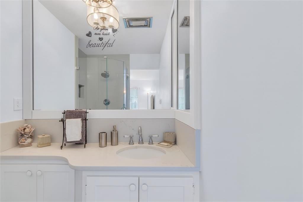 1198 Hillsboro Mile, Unit 212 Hillsboro Beach, FL 33062 - Photo 22 of 64 a bathroom with a sink and a mirror