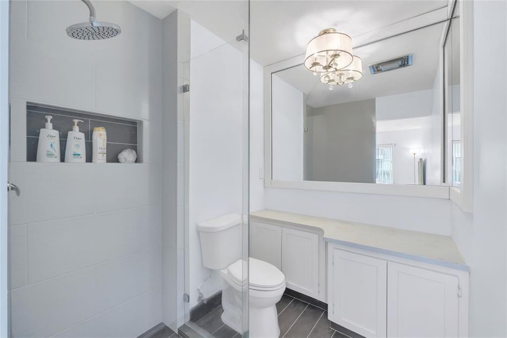 1198 Hillsboro Mile, Unit 212 Hillsboro Beach, FL 33062 - Photo 24 of 64 a bathroom with a toilet sink and mirror