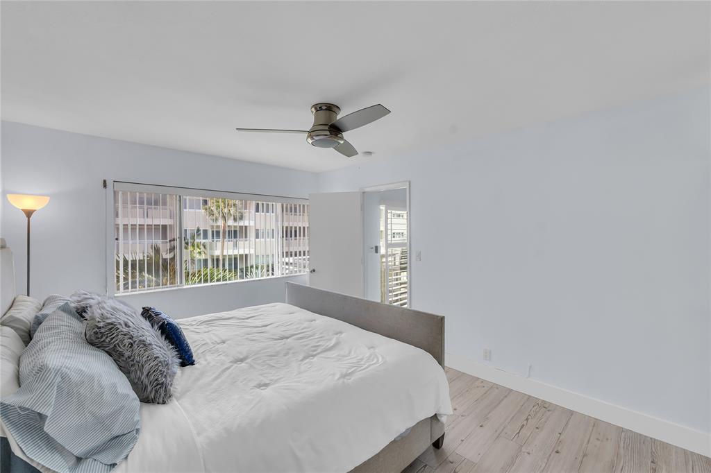 1198 Hillsboro Mile, Unit 212 Hillsboro Beach, FL 33062 - Photo 26 of 64 a bedroom with a bed and a window