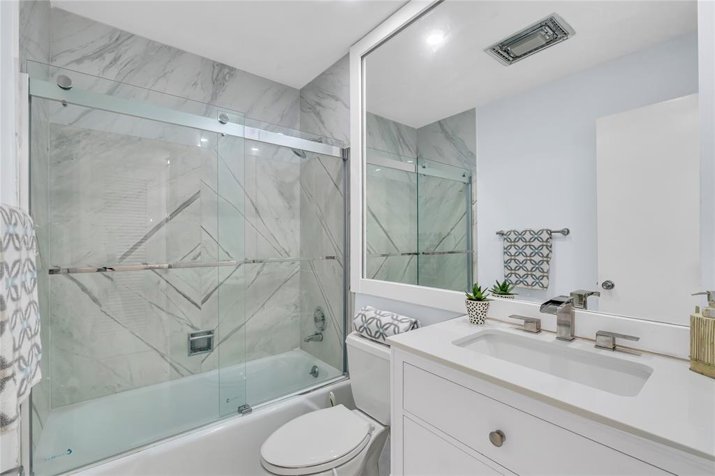 1198 Hillsboro Mile, Unit 212 Hillsboro Beach, FL 33062 - Photo 29 of 64 a bathroom with a sink toilet vanity and shower