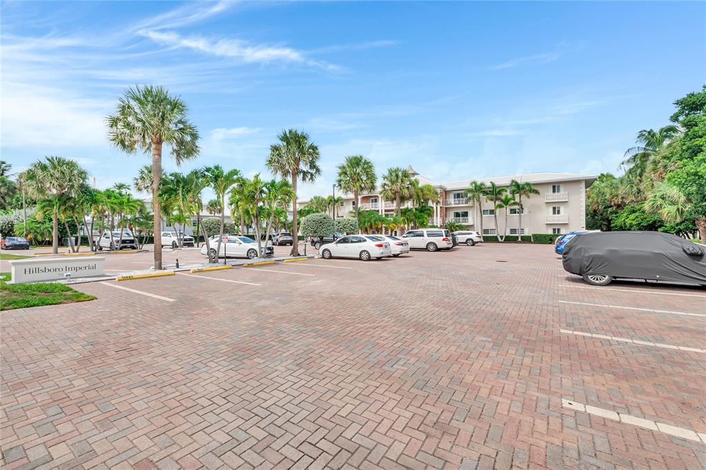 1198 Hillsboro Mile, Unit 212 Hillsboro Beach, FL 33062 - Photo 60 of 64 a view of a street with a building and trees in the background