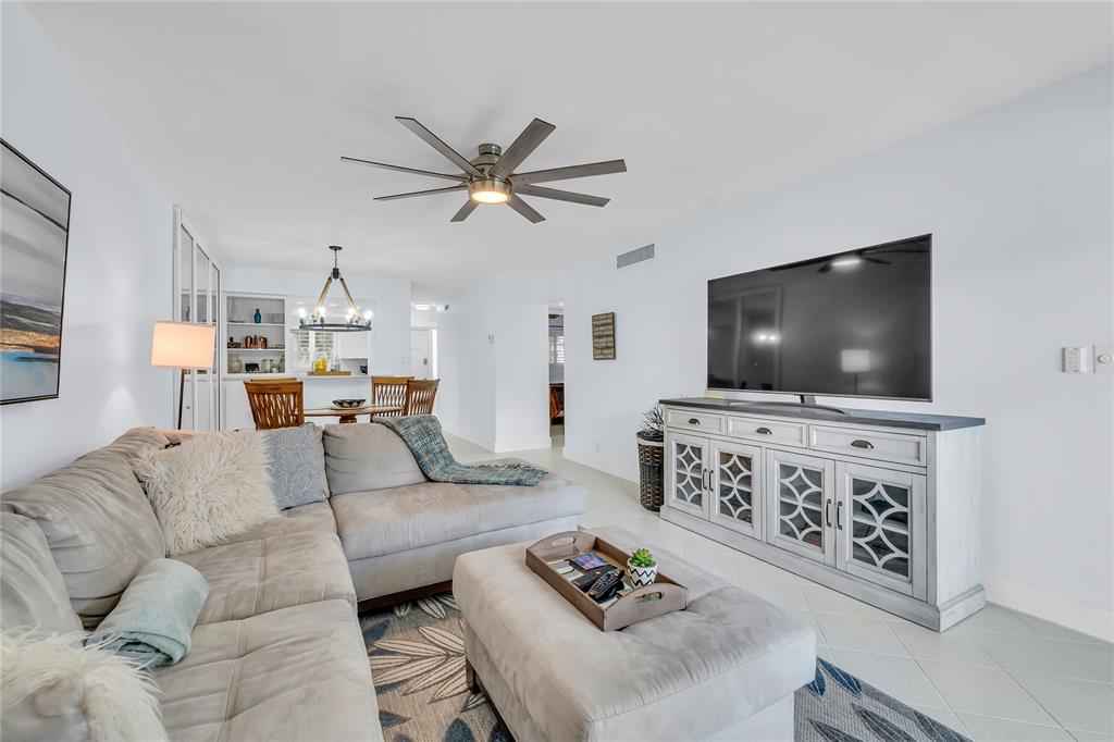 1198 Hillsboro Mile, Unit 212 Hillsboro Beach, FL 33062 - Photo 7 of 64 a living room with furniture and a flat screen tv