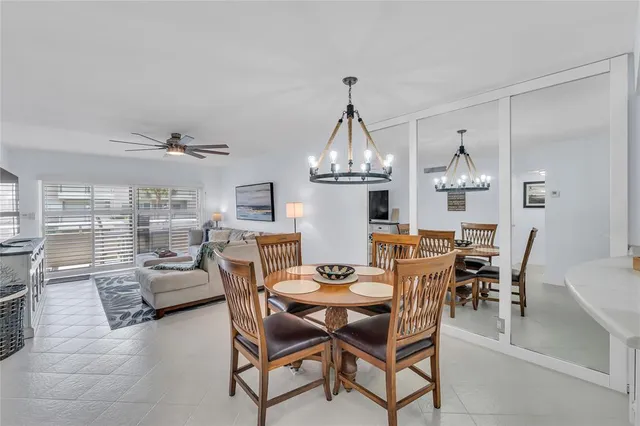 a view of a dining room with furniture a chandelier and wooden floor