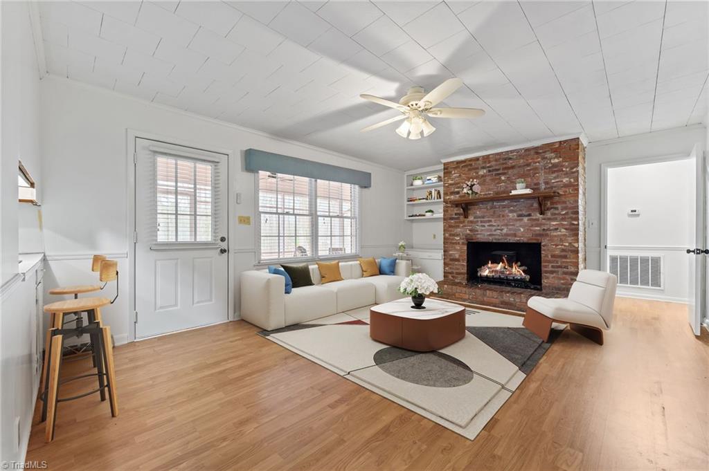 217 Lambert Road Biscoe, NC 27209 - Photo 19 of 28 Virtually Staged - Den Area. Door to left leads to screened in back porch & back yard. Door to right leads to bedrooms.
