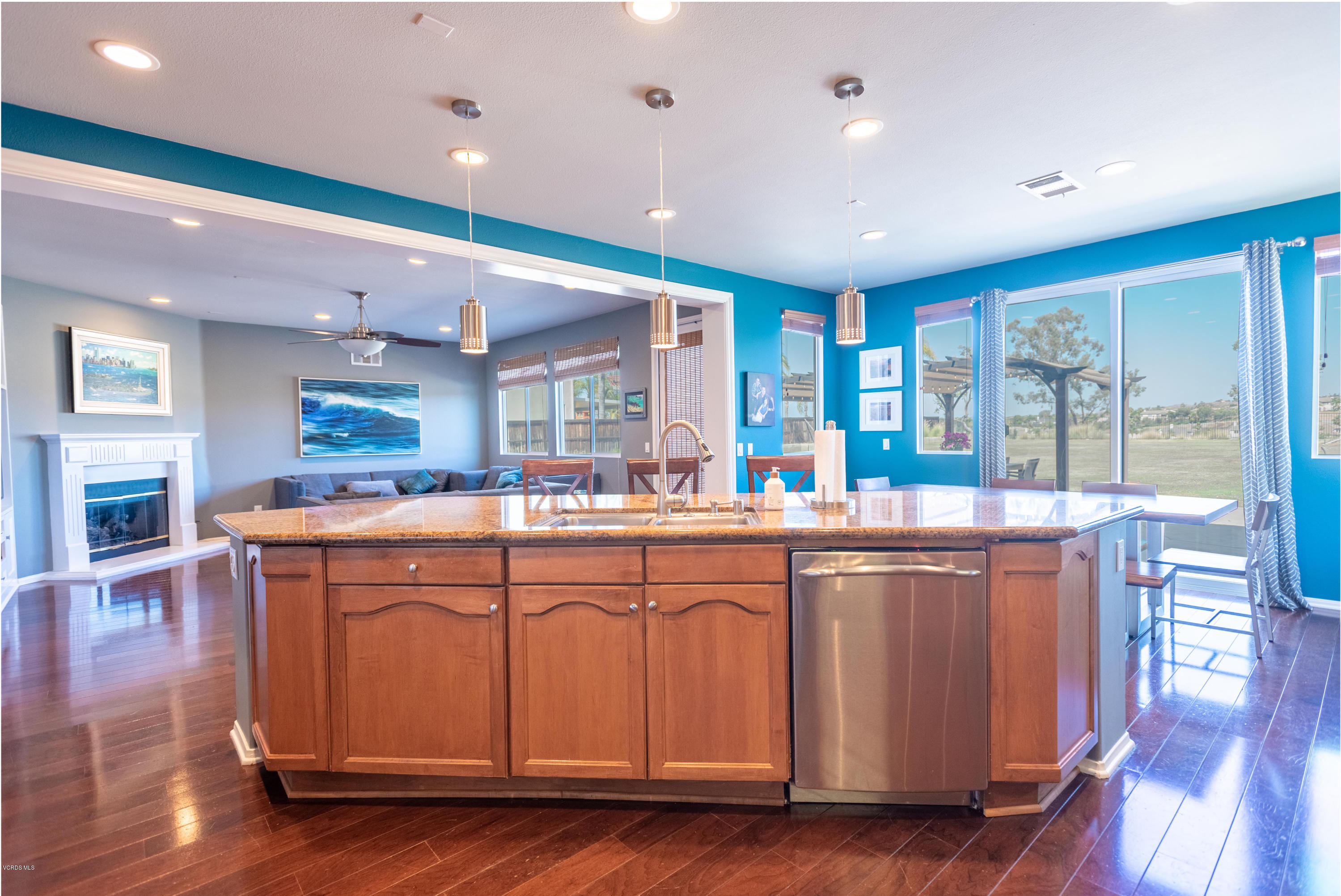 17118 Raindrop Court Riverside, CA 92503 - Photo 24 of 68 a large kitchen with stainless steel appliances granite countertop a large kitchen island and a wooden floors