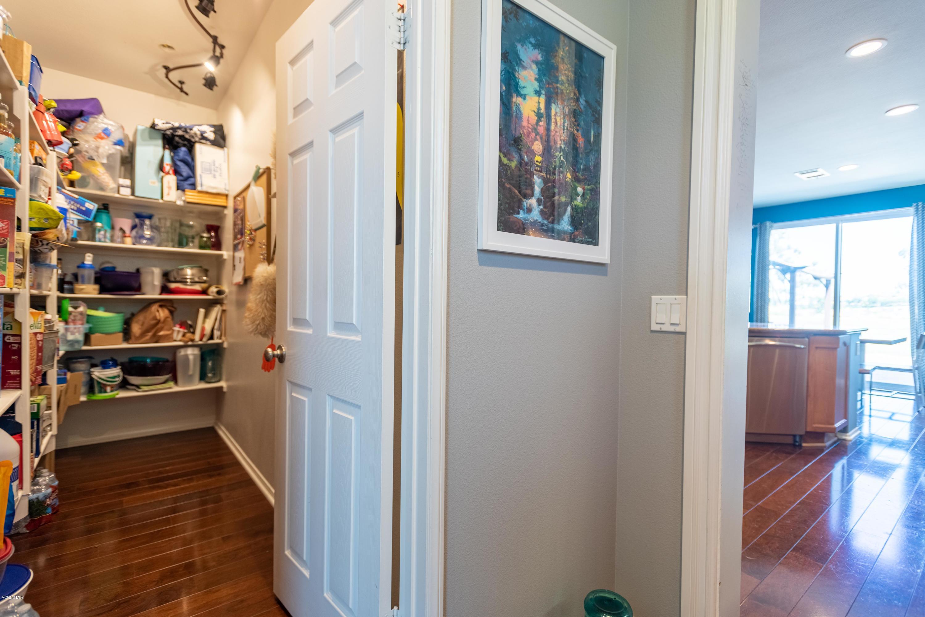 17118 Raindrop Court Riverside, CA 92503 - Photo 27 of 68 a view of a hallway with shelves and wooden floor