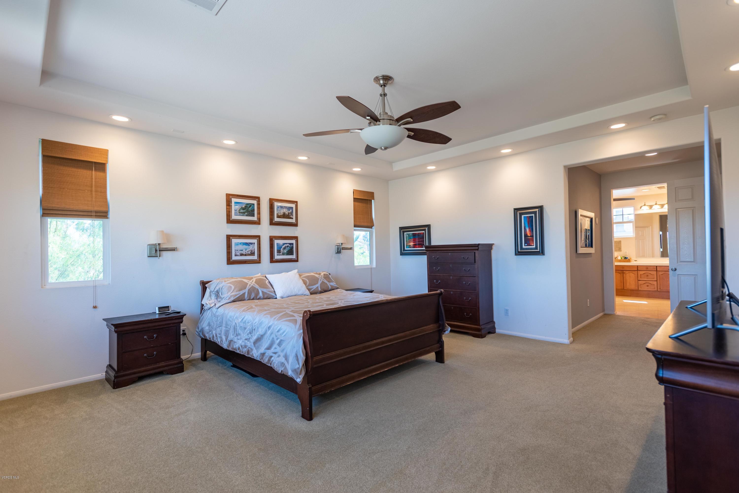 17118 Raindrop Court Riverside, CA 92503 - Photo 39 of 68 a bedroom with a bed and a chandelier