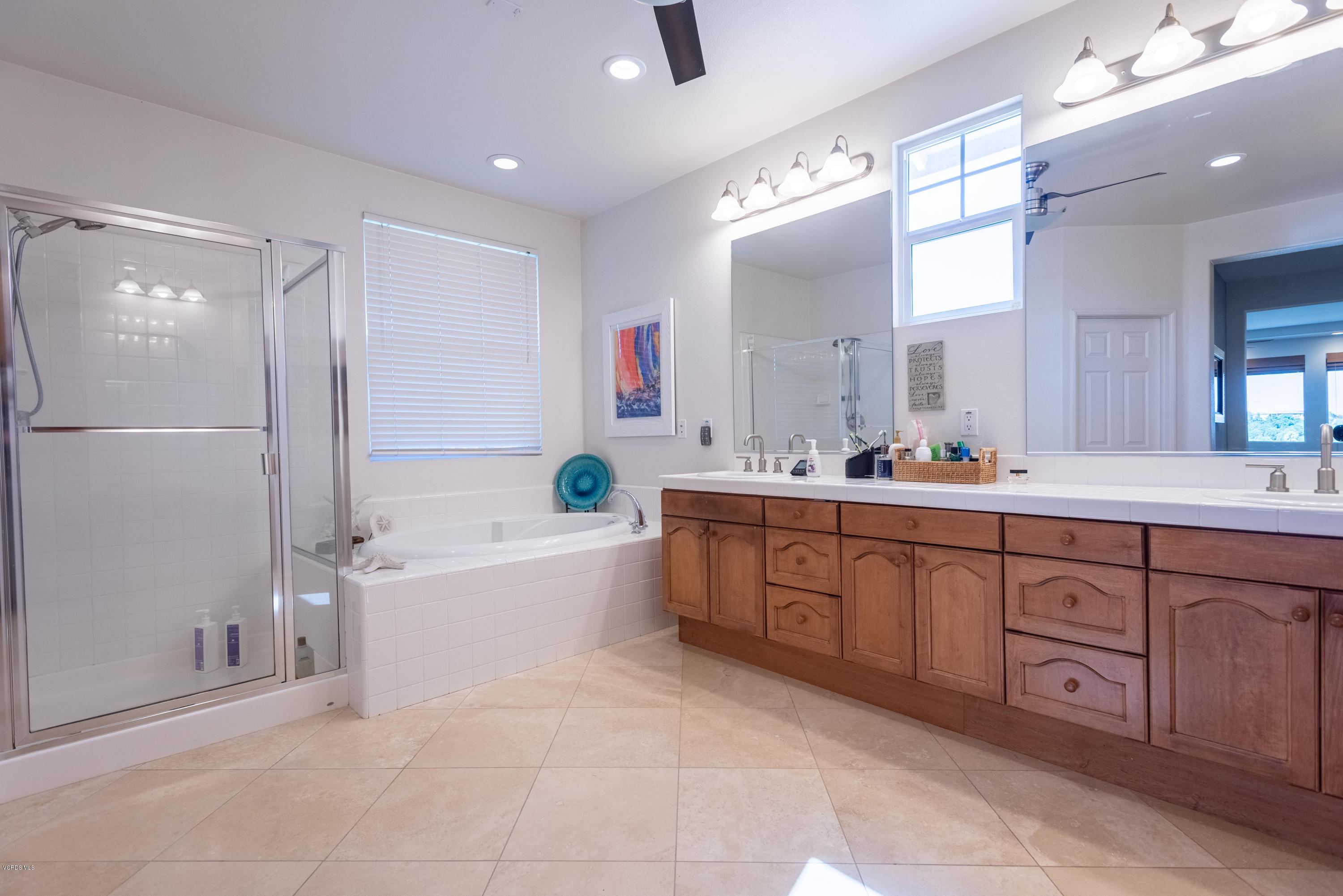 17118 Raindrop Court Riverside, CA 92503 - Photo 42 of 68 a spacious bathroom with a tub sink and mirror