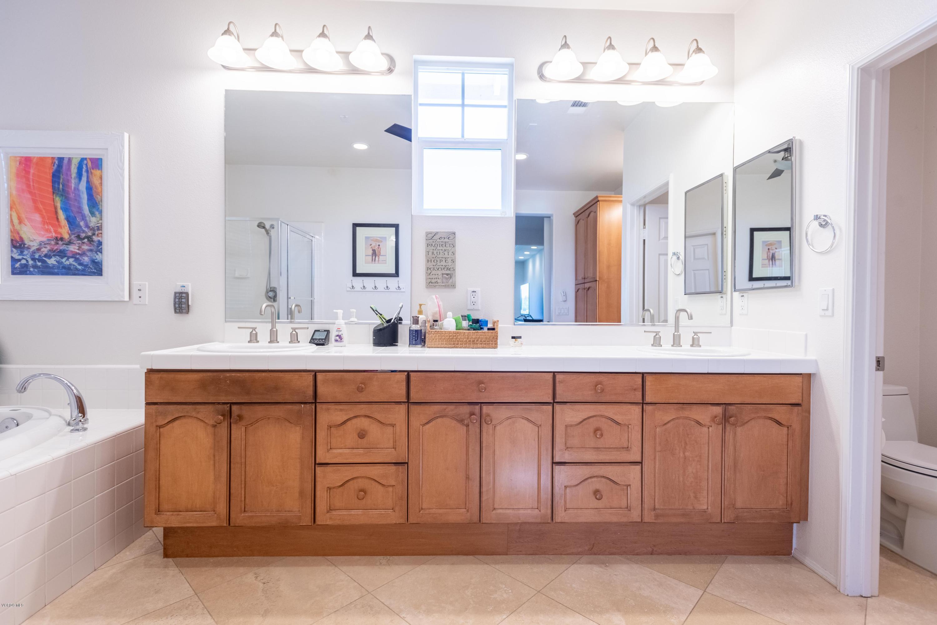 17118 Raindrop Court Riverside, CA 92503 - Photo 43 of 68 a spacious bathroom with a sink double vanity and a mirror