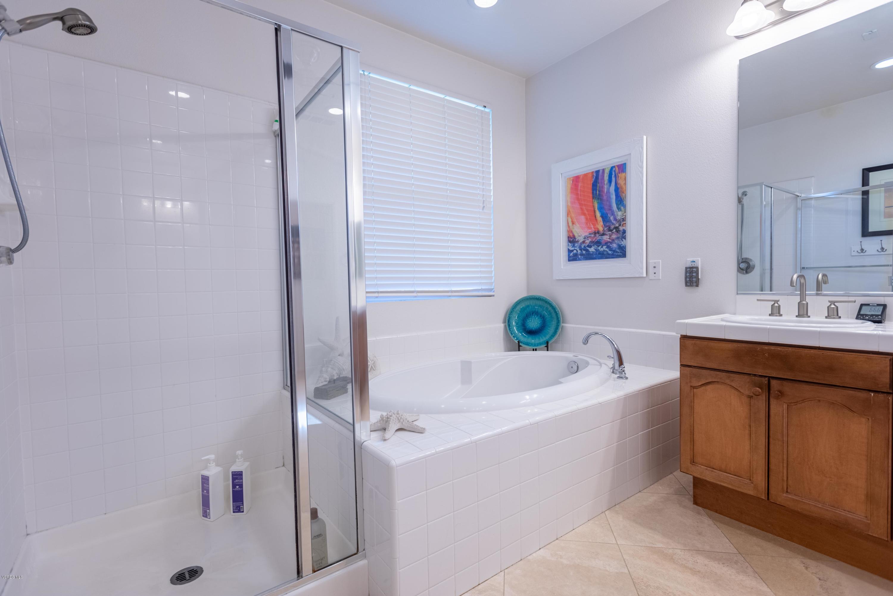 17118 Raindrop Court Riverside, CA 92503 - Photo 44 of 68 a bathroom with a tub a sink and a shower