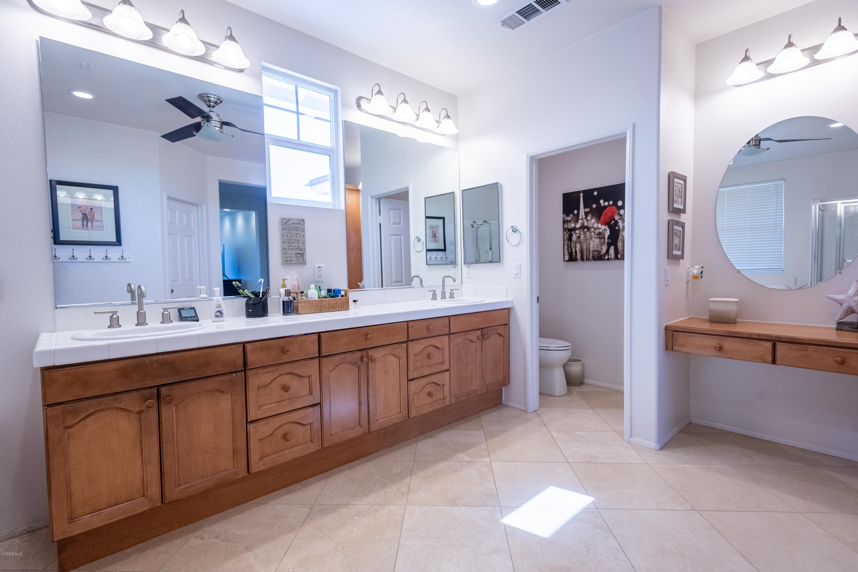 17118 Raindrop Court Riverside, CA 92503 - Photo 45 of 68 a spacious bathroom with a double vanity sink a mirror and a bathtub