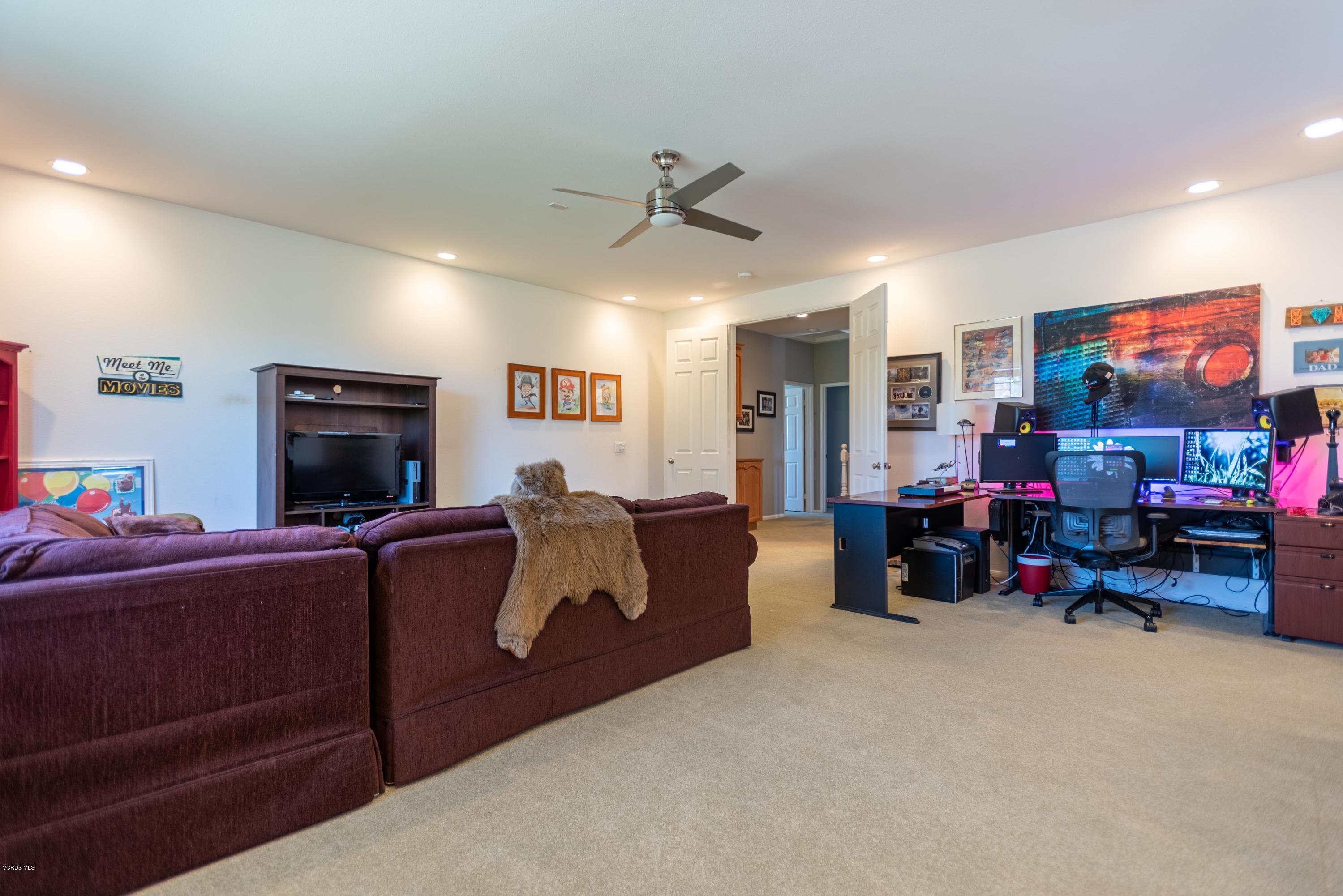 17118 Raindrop Court Riverside, CA 92503 - Photo 52 of 68 a living room with furniture and a flat screen tv