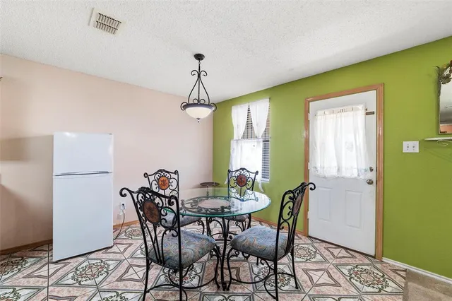 a view of a dining room with furniture and window