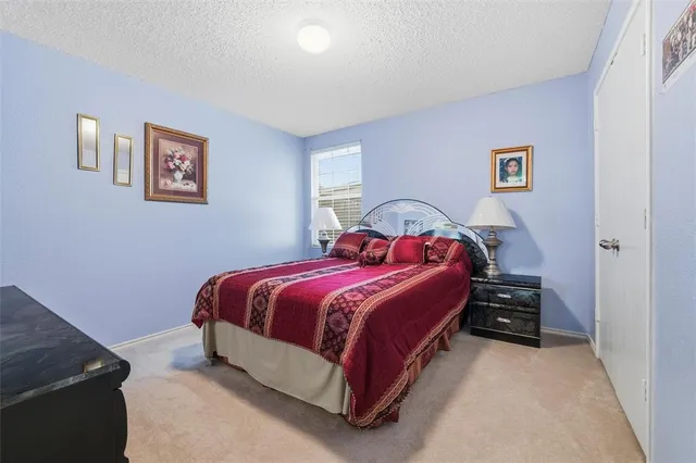 a bedroom with a bed and a desk