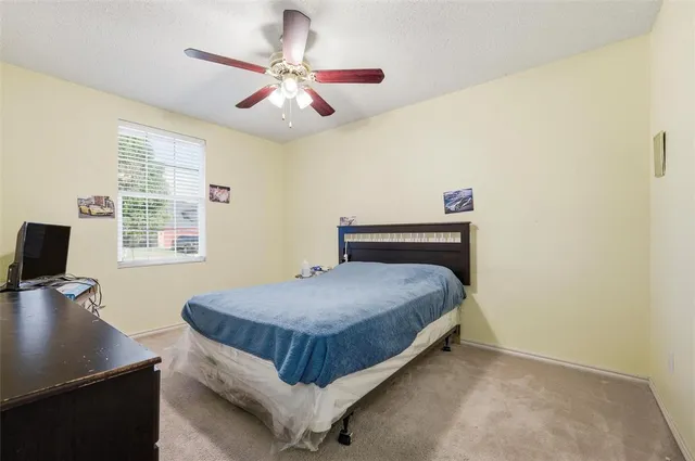 a bedroom with a bed and a desk