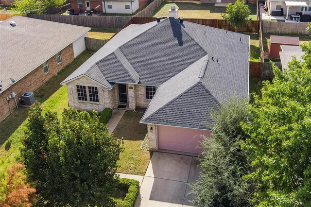 an aerial view of a house with a yard and plants