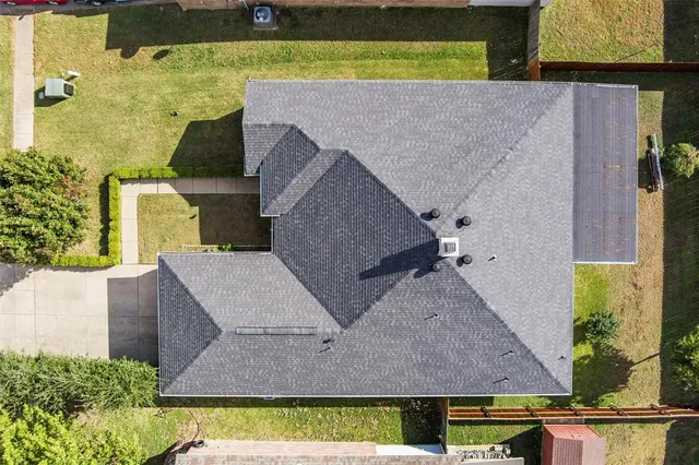 an aerial view of a house with a yard