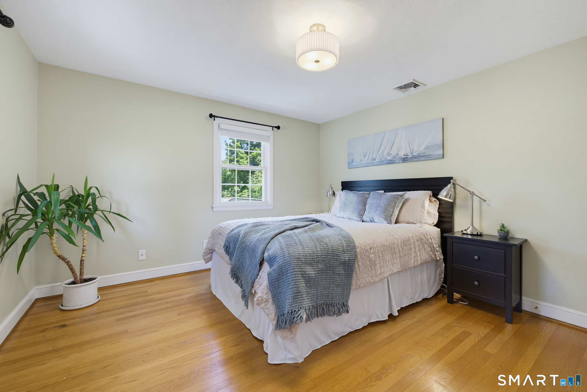 224 Spring Street Manchester, CT 06040 - Photo 17 of 39 a bedroom with a bed and a potted plant