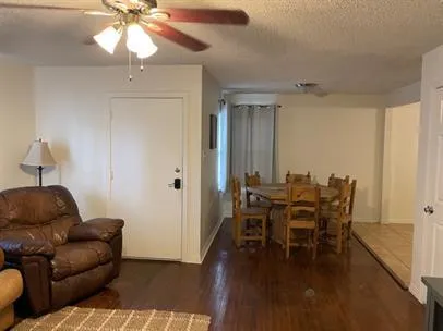 a dining room with furniture and wooden floor