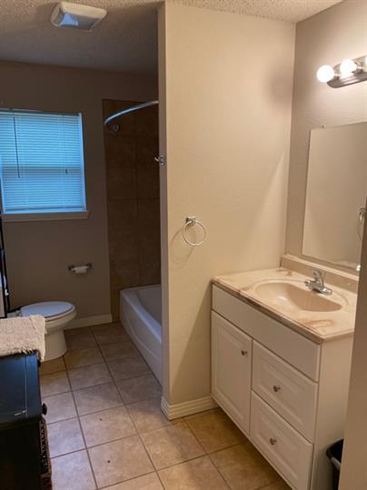 2014 49th Street Lubbock, TX 79412 - Photo 4 of 16 a bathroom with a granite countertop sink a toilet and a bathtub