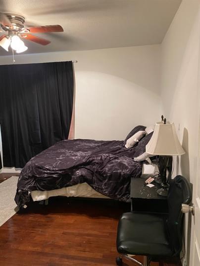 2014 49th Street Lubbock, TX 79412 - Photo 5 of 16 a bedroom with a bed and a chandelier