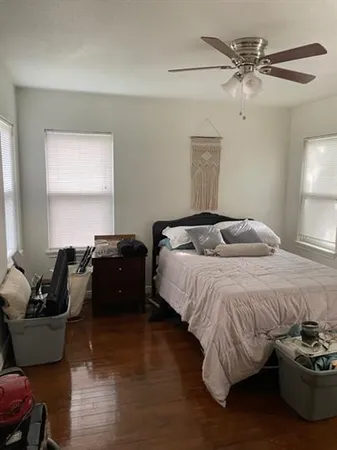 a bedroom with a bed and a couch