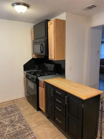 a kitchen with a stove and a refrigerator