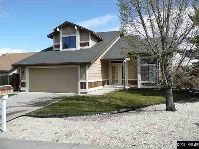 5738 Simons Drive Reno, NV 89523 - Photo 1 of 13 a front view of a house with a yard and garage