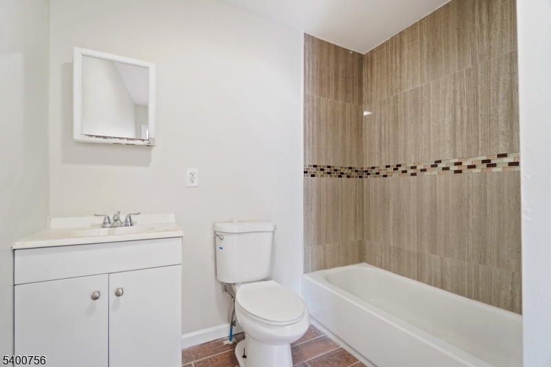 874 South 16th Street Newark, NJ 07108 - Photo 12 of 29 a bathroom with a sink a toilet and shower