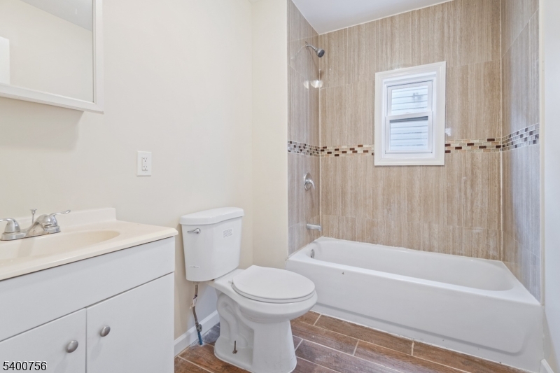 874 South 16th Street Newark, NJ 07108 - Photo 13 of 29 a bathroom with a toilet a sink and bathtub