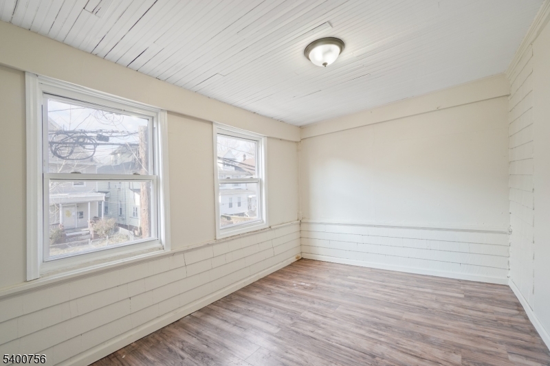 874 South 16th Street Newark, NJ 07108 - Photo 15 of 29 a view of an empty room with wooden floor and a window