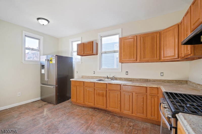 874 South 16th Street Newark, NJ 07108 - Photo 19 of 29 a kitchen with stainless steel appliances granite countertop a refrigerator and a sink