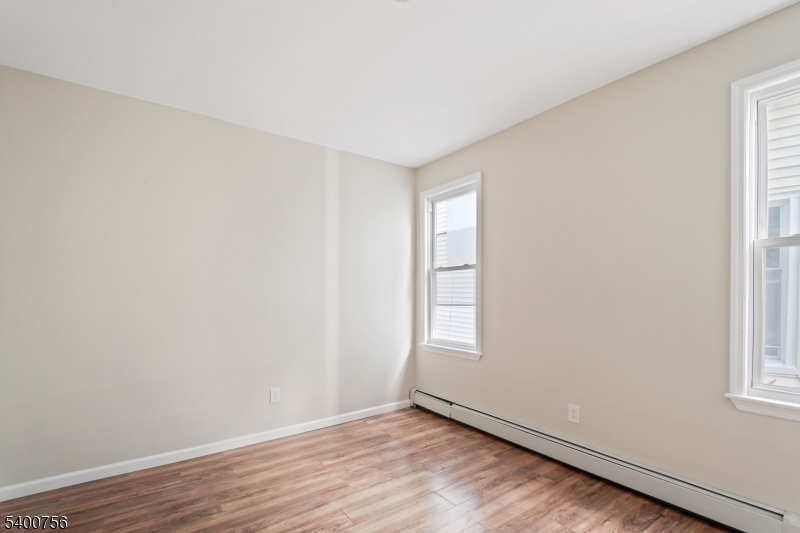 874 South 16th Street Newark, NJ 07108 - Photo 25 of 29 an empty room with wooden floor and windows