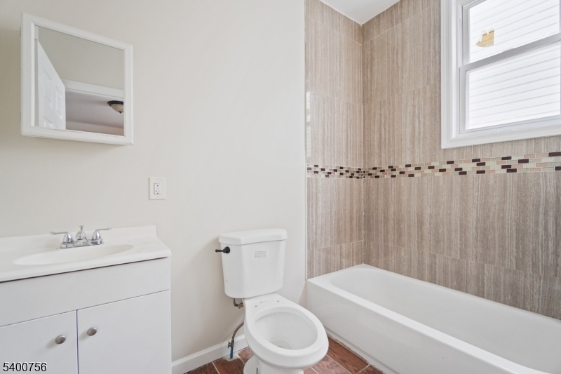 874 South 16th Street Newark, NJ 07108 - Photo 26 of 29 a bathroom with a sink toilet and bathtub