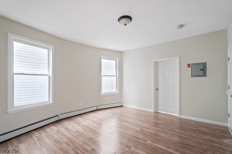 874 South 16th Street Newark, NJ 07108 - Photo 5 of 29 a view of an empty room with wooden floor and a window