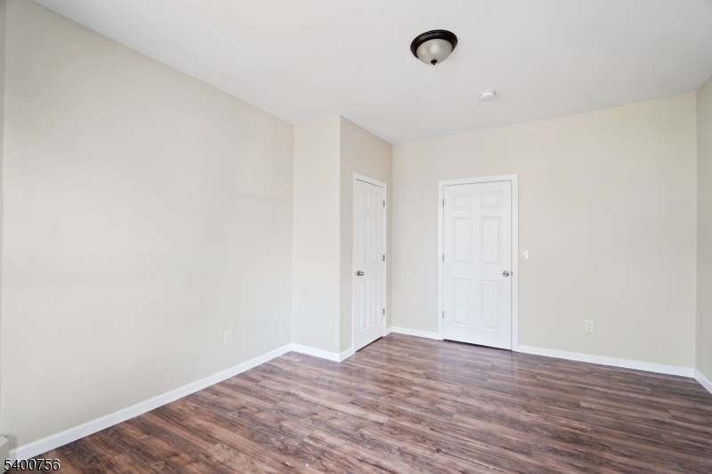 874 South 16th Street Newark, NJ 07108 - Photo 7 of 29 a view of an empty room with wooden floor