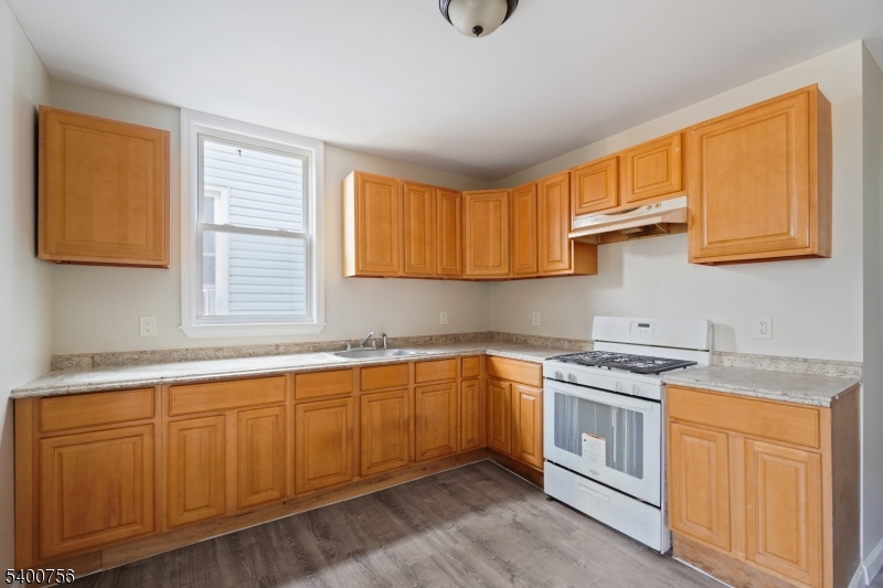 874 South 16th Street Newark, NJ 07108 - Photo 10 of 29 a kitchen with a sink stove and cabinets