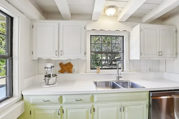 a kitchen with a sink cabinets and window