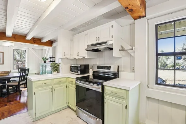 a kitchen with cabinets appliances and a counter space
