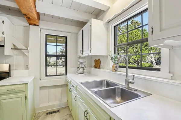 a kitchen with stainless steel appliances granite countertop a sink and a window