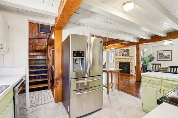 a kitchen with stainless steel appliances kitchen island granite countertop a refrigerator and a stove top oven