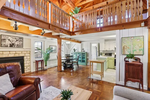 a living room with furniture a fireplace and a large window