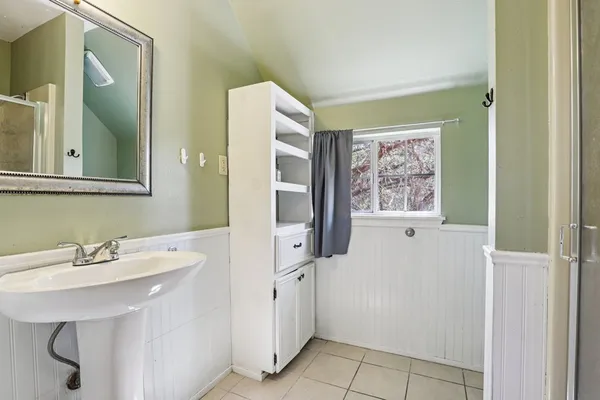 a view of washer and dryer with bathroom in the background