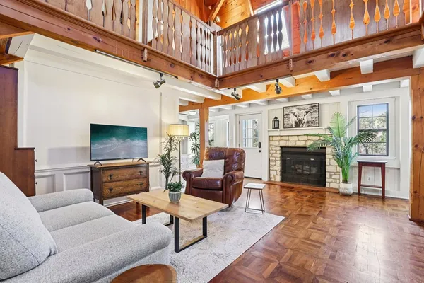 a living room with furniture a fireplace and a flat screen tv