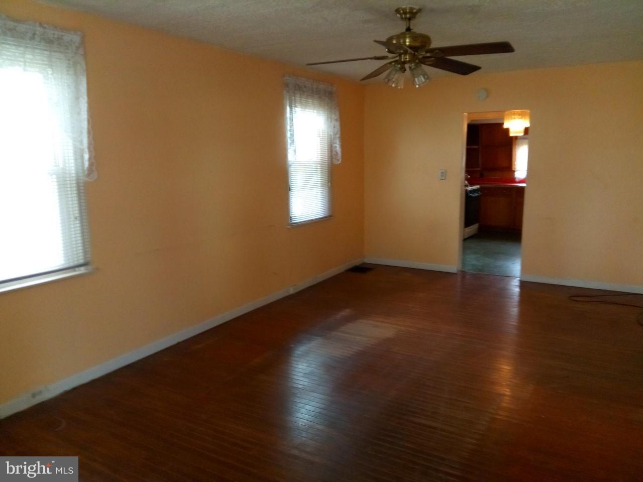 3321 Fairview Road Baltimore, MD 21207 - Photo 3 of 12 an empty room with wooden floor and windows