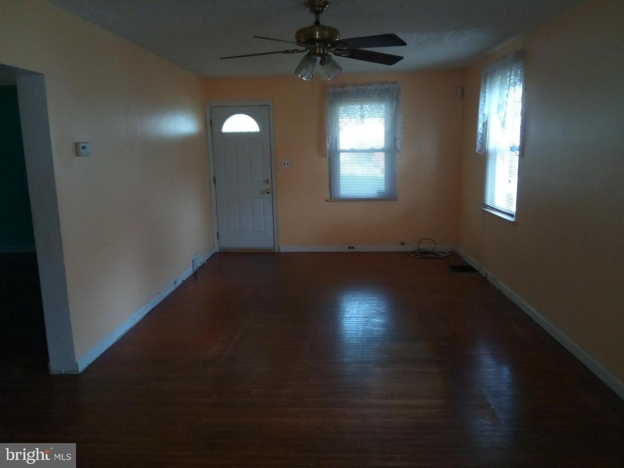 3321 Fairview Road Baltimore, MD 21207 - Photo 4 of 12 wooden floor in an empty room with a window