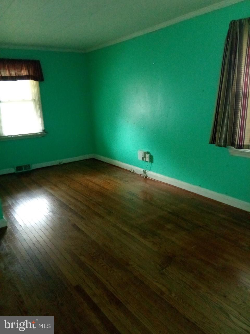 3321 Fairview Road Baltimore, MD 21207 - Photo 6 of 12 a view of a big room with wooden floor and windows