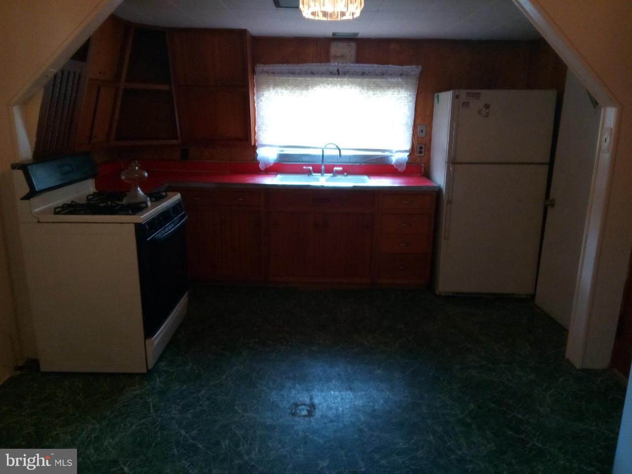 3321 Fairview Road Baltimore, MD 21207 - Photo 8 of 12 a kitchen that has a sink stove and cabinets