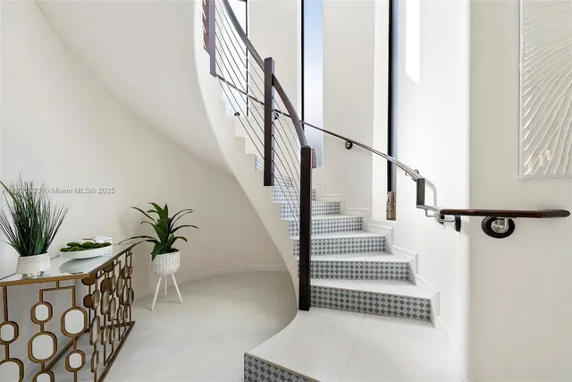 a view of entryway with wooden floor and vase sitting on a table